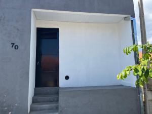 a door on the side of a building with stairs at Kitnet aconchegante próximo a unesp in Botucatu