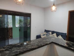 a kitchen with a granite counter top in a room at Eloá Mar's Corner in Angra dos Reis