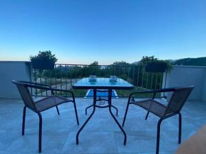 a table and two chairs on a patio at Villa Oaza in Bar