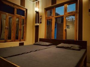 a bedroom with a bed with two pillows on it at Amritganga Homestay in Uttarkāshi