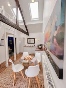 a living room with white chairs and a large painting at Stylish Loft in Stockport - Free Parking - 10 min to Manchester - Flat 1 in Stockport
