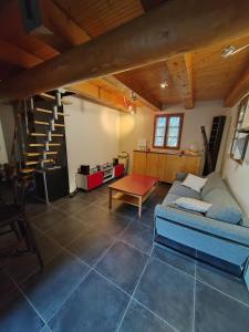 a living room with a couch and a table at Maison individuelle, au calme in Visan