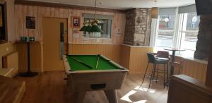 a room with a pool table and a bar at The Havelock in Nairn