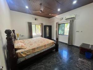 a bedroom with a bed in a room at Lake View in Kundapur