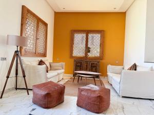 a living room with a couch and two ottoman at Villa Africa in Essaouira