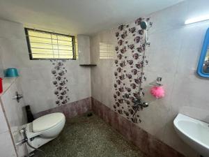 a bathroom with a toilet and a sink at Lake View in Kundapur