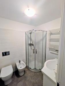 a bathroom with a shower and a toilet and a sink at Back in Tide , frontal sea view window, no AC, Pet friendly in Riomaggiore +12 photos