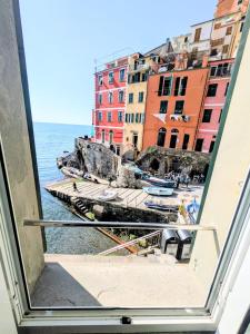 a view of the ocean from a window at Back in Tide , frontal sea view window, no AC, Pet friendly in Riomaggiore