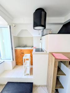 a small kitchen with a white counter and a sink at Back in Tide , frontal sea view window, no AC, Pet friendly in Riomaggiore