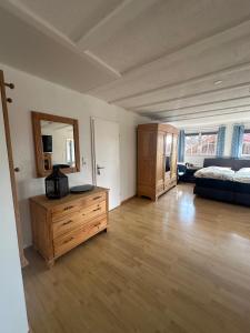 a large living room with a bed and a wooden dresser at Haus am Murgtalpfad 1 und 2 in Rickenbach