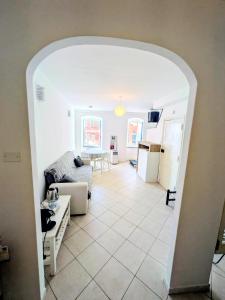 a living room with an arch leading to a kitchen at Back in Tide , frontal sea view window, no AC, Pet friendly in Riomaggiore