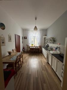 a kitchen with a table and a dining room at Stacja Centrum in Częstochowa