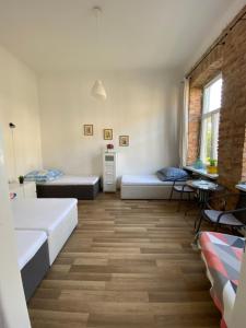 a living room with two beds and a table at Stacja Centrum in Częstochowa