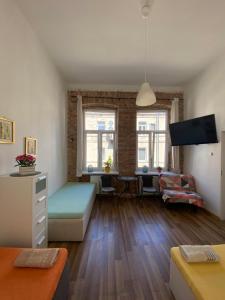 a living room with a bed and a couch at Stacja Centrum in Częstochowa