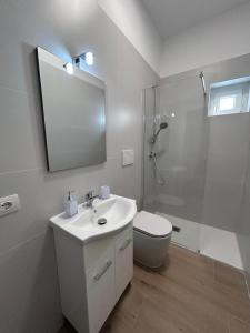 a bathroom with a toilet and a sink and a shower at Nuvola Hosting in Segrate +7 photos