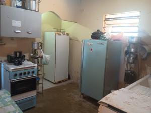 a kitchen with two refrigerators and a stove at Casa em Araruama com 3 quartos e muito arejada in Araruama