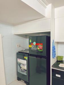 a kitchen with a stove and a refrigerator at Êm Attic Hai Phong Old Town in Hai Phong