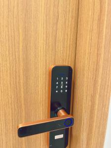 a cell phone sticking out of a door at Êm Attic Hai Phong Old Town in Hai Phong