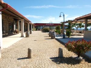a brick walkway in front of a building at Tranca da Barriga - Casa do Vinho by Quinta De São Tiago in Covilhã