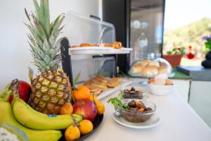 a plate of fruit sitting on a counter next to a table at Il Torrazzo da Francesca in San Vito lo Capo +26 photos