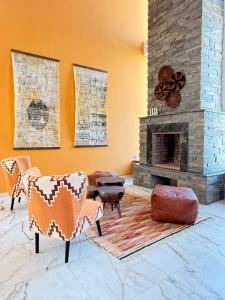 a living room with two chairs and a fireplace at Villa Africa in Essaouira