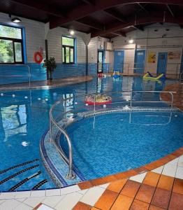 a large swimming pool in a building at 20 Strawberry Hill cosy cottage sleeps 5 in Hayle