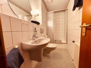 a small bathroom with a sink and a toilet at Kaiserstühler-Hof in Breisach am Rhein +126 photos