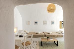 a white room with a bed and a table at Just Blue in Oia +149 photos