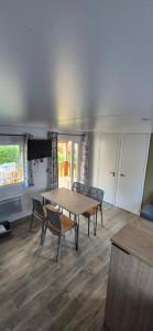 a room with a table and chairs and a table and a table and chairs at Monpetitmobilhome in Ascarat
