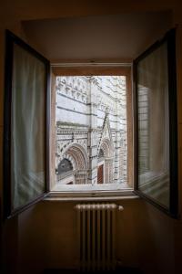 an empty room with a large window at Palazzo del Magnifico B&B in Siena