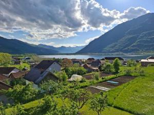 a village with a lake and mountains in the background at Apartment Mountain Paradise Plav in Plav