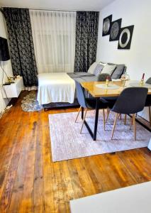 a bedroom with a bed and a table with chairs at Old Town Maglaj 2, Center ,Parking in Maglaj