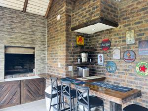 a brick wall with a table and chairs in a restaurant at Vaal Dam Getaway in Denysville