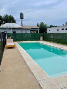 a swimming pool in a backyard with a water tower at Complejo Juan Pablo in Colón +8 photos