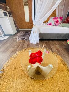 a room with a table with a hat and a bed at Ô Balcon in Sainte-Rose