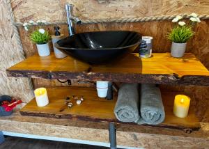 a bathroom with a sink on a wooden counter at Ô Balcon in Sainte-Rose