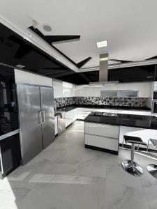 a kitchen with stainless steel appliances and black and white at Exceptional Villa Pool in Oujda