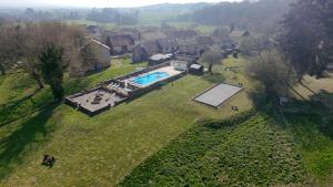 an aerial view of a house with a swimming pool at Gites Le Chezeau in Saint-Amand-Magnazeix