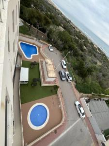an aerial view of a building with cars parked next to a pool at AL045 Pinada Beach III La Mata in La Mata