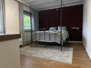 a bedroom with a canopy bed with a rug at Villa France in Sevenum +15 photos