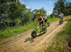 a group of people riding bikes on a dirt road at Apartament Bieszczady in Myczkowce