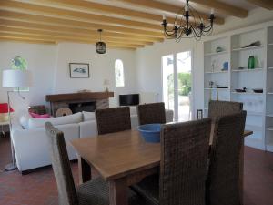 a living room with a table and a couch at Renovated villa by the ocean in Barbâtre