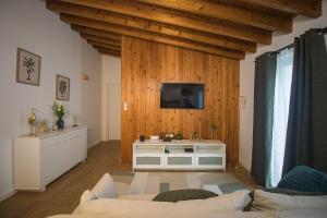 a living room with a tv on a wooden wall at Entre Raizes in Remédios