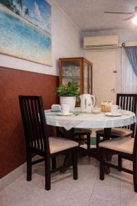 a dining room table with chairs and a white tablecloth at Mistela Altos Crucero Boutique - Alojamiento temático - Zona Residencial Ciudad - Viajes al Aeropuerto - in Godoy Cruz