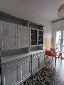 a kitchen with gray cabinets and a dining room at UN BEL POSTO AL MARE in Savona +17 photos