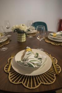 a wooden table with a plate of food on it at Entre Raizes in Remédios +25 photos