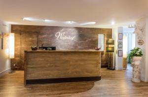 a lobby with a bar with the name marilyn on the wall at Berghaus - Der Westerhof Hotel in Tegernsee