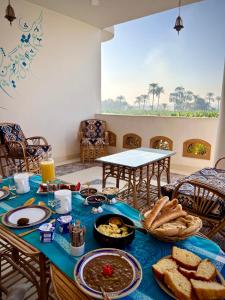 a table with food and bread on top of it at Dar Lina Guesthouse Luxor in Luxor