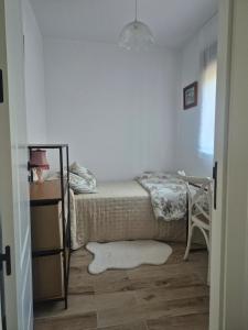 a bedroom with a bed and a table and a rug at Casa La Candela in Montemayor del Río