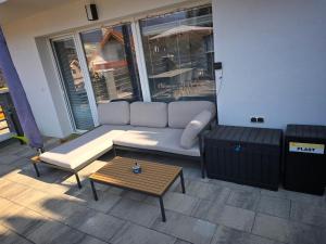 a living room with a couch and a coffee table at Dom pri jazere Nitrianske Rudno in Kostolná Ves